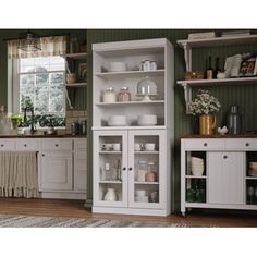 a kitchen with green walls and white cabinets