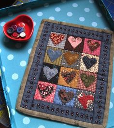 a blue table topped with lots of different colored hearts