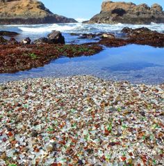 there are many glass bottles on the beach and in the water, all by itself