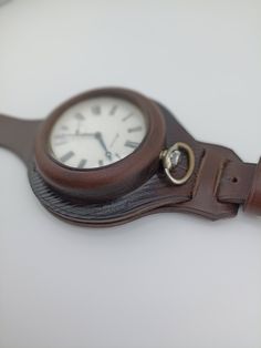 Handmade leather pocket watch case. Made of premium quality leather. For watches 55 mm in diameter, available colors in the last photo: 1. cognac 2. black 3. brown 4. sand color Personalization for free In the photo the color is brown Note: The watches shown in the photo are not for sale, this is for example only Classic Brown Watch With Round Case, Brown Leather Watch Accessories With Round Case, Brown Leather Watch With Round Case, Brown Chronometer Watch For Gift, Brown Chronometer Watch As Gift, Timeless Brown Watch With Round Case, Vintage Brown Leather Watches, Vintage Brown Watch With Leather Strap Accessories, Timeless Chronometer Watch Accessories For Everyday