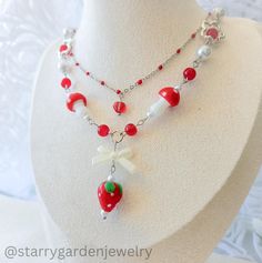 Strawberry and Mushroom Charm Necklace - "Strawberry Fields" 🍓🤍 Featuring vibrant red mushroom beads, a charming strawberry bead, a white bow bead, delicate white faux pearls and red glass beads. ✨️  ➤ 𝘈𝘣𝘰𝘶𝘵 𝘖𝘶𝘳 𝘕𝘦𝘤𝘬𝘭𝘢𝘤𝘦𝘴 ❀ Please note that each necklace is meticulously handmade, resulting in slight variations in shapes and patterns from the product images. ❀ Additionally, colors may vary slightly from what you see on your screen, due to differences in screen settings. ➤ 𝘑𝘦? Necklace Fairycore, Cottagecore Necklace, Fairycore Necklace, Mushroom Beads, Strawberry Jewelry, Strawberry Necklace, Mushroom Necklace, Mushroom Jewelry, Red Mushroom