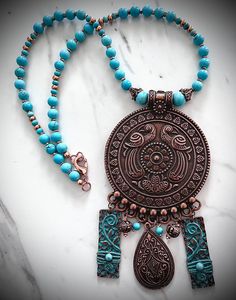 Handmade natural turquoise and genuine copper medallion ethnic style necklace with repurposed dangle components. 18.25" end to end including lobster claw clasp and rings; medallion drop is approximately 4.5". See photo to see how this lovely piece drapes. Handmade Bohemian Medallion Necklace, Bohemian Copper Necklace For Festivals, Bohemian Copper Necklace For Festival, Bohemian Festival Necklace In Copper, Bohemian Turquoise Pendant Necklace With Patina, Traditional Blue Turquoise Necklace With Patina, Bohemian Turquoise Jewelry With Patina, Bronze Bohemian Jewelry With Patina, Bohemian Bronze Jewelry With Patina