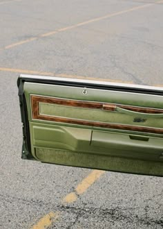 the door panel of a green car is open and there is no image on it