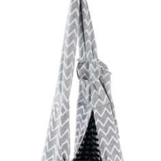 a gray and white bag with an arrow on the front, hanging from a hook