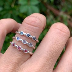 Wear them on their own or stacked all the way up your finger, our gemstone stacking bands in reclaimed sterling silver are the perfect addition to your daily jewels, a perfect gift for a loved one or yourself. Available in Ruby, Rhodolite Garnet, London Blue Topaz, Peridot, Amethyst, Blue Zircon, Spessartite Garnet, and Moonstone or mixed (pick your own, message us for your selection) Each Stone measures approx 2.5mm. These beautiful pieces are handmade to order in Emily's Hudson Valley studio. Handmade Fine Jewelry Stackable Promise Rings, Handmade Fine Jewelry Stackable Rings For Promise, Handmade Stackable Rings For Promise Fine Jewelry, Adjustable Sapphire Jewelry With Birthstone, Spiritual Sterling Silver Stackable Promise Rings, Sterling Silver Birthstone Jewelry With Round Band, Sterling Silver Open Band Stackable Fine Jewelry Rings, Fine Jewelry Sterling Silver Open Band Stackable Rings, Sterling Silver Stackable Open Band Rings, Fine Jewelry