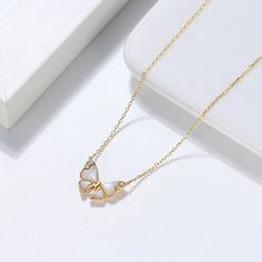 Our gorgeous Gold chain is a classic butterfly design pendant necklace with moissanite diamond and a pearl that has been designed for women. They are beautiful on their own, It gives you a confident feeling and can guarantee you an attractive and luxurious appearance. The modern and trendy gold chain contains 100% real gold material with a stamp for authenticity and it's safe for all skin types. They are nickel-free and their high polished finish gives them a fine 18K shine of purest gold materi Gold Butterfly Necklace, Butterfly Necklace Gold, Gold Butterfly, Butterfly Necklace, Pure Gold, Butterfly Design, Moissanite Diamonds, Real Gold, Gold Material