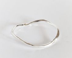 Irregular silver bracelet.   Its modern design makes it a perfect gift for strong woman. This wavy bangle is made of an  hypoallergenic alloy and silver plated (10 micron) to give its polished shiny look.  I made it in my Spain workshop with high quality materials which ensures a perfect finish with great durability. It is an easy wear piece of jewelry that you can rock both with jeans or a cocktail dress.  🎁This stackable bracelet is also available in yellow gold https://www.etsy.com/listing/1 Sterling Silver Bangle With A Modern Twist, Modern Twist Silver Bangle Bracelets, Silver Bangle With A Modern Twist, Modern Twist Sterling Silver Bracelet For Gift, Modern Twist Sterling Silver Bracelet Gift, Modern Twist Sterling Silver Bracelet As Gift, Gift Sterling Silver Bangle Bracelet With Modern Twist, Modern Handmade Sterling Silver Bangle Bracelet, Modern Handmade Silver Bangle