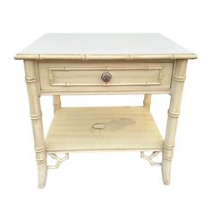 a small white table with drawers on one side and an open drawer on the other