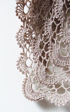 crocheted doily on white background with small holes