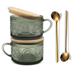 three green glass mugs with wooden spoons next to each other