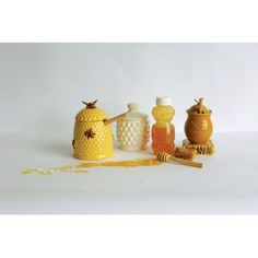 three honey jars and two bees on a white background