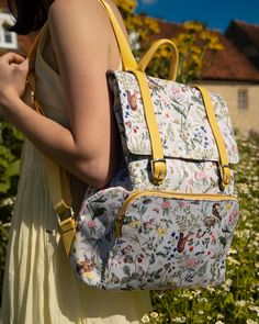 Brighten your day with the joyful Meadow Creatures Backpack in charming Marshmallow Yellow. This compact yet spacious bag is adorned with a delightful print of playful meadow creatures, adding a whimsical touch to your travels. Ideal for lighter journeys, it features a zipped front pocket, two inner compartments, and a roomy interior to keep your essentials organized. Finished with vintage-inspired vegan leather buckled straps, this bag effortlessly blends practicality with nostalgic charm. The Spring Backpack With Floral Print For Everyday Use, Floral Print Backpack For Everyday Use In Spring, Spring Floral Print Backpack For Everyday Use, Spring Standard Backpack With Adjustable Strap, Spring Backpack With Adjustable Strap, Spring Travel Backpack With Adjustable Strap, Spring Floral Print Backpack For Daily Use, Travel Backpack With Adjustable Strap For Spring, Everyday Spring Rectangular Backpack