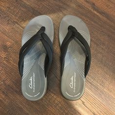 Size 8 New Without Tags Gray Synthetic Slippers With Cushioned Footbed, Non-slip Gray Slip-on Flip Flops, Gray Sandals With Arch Support And Round Toe, Gray Round Toe Sandals With Arch Support, Clarks Shoes, Women's Shoes Sandals, Black Gray, Shoes Sandals, Black And Grey