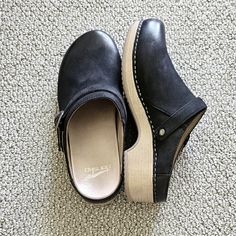 Dansko "Berry" Style Burnished Nubuck Suede Clogs In Black. Only Worn Twice Indoors. Adjustable Strap Can Be Worn Around Ankle. Wood Heel And No-Slip Soles. Size 38 (8). Smoke And Pet Free Home. Dansko Clogs, Suede Clogs, Black Only, Wood Heel, Dansko Shoes, Mule Clogs, Mules Shoes, Black Tan, Black And Tan