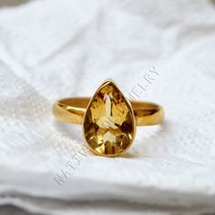 Citrine gold ring, 14K yellow gold citrine ring, natural pear cut citrine gemstone jewelry, romantic gift ring, gold ring, wedding gift ring Citrine is said to ignite creativity, aid in decision making, ignite playfulness, support creativity and money making. Physically, citrine is said to support the digestive system and boost metabolism to aid with physical energy and weight loss. The 14K yellow solid gold bezel and solid yellow gold ring are both shined to an extremely high polish. All rings are packaged and shipped in a beautiful ring box.  The main stone is natural, pear cut, Citrine. Gemstone Size Approx : 12 x 8 mm The pictures have been enlarged to show the details. The price is for a 14k gold ring, if you want to order the ring in 18k or 22k gold please convo me prior to purchase. Gold Ring Wedding, Citrine Ring, Citrine Gemstone, Lovely Ring, Gift Ring, 14k Gold Ring, Boost Metabolism, Romantic Gift, Digestive System