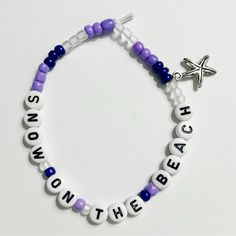 a beaded bracelet with the words beach on the front and starfish on the back