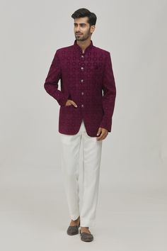 Wine bandhgala with floral pattern thread and sequin embroidery. Comes with contrast white trouser.
Components:2
Pattern:Embroidered
Type of Work:Thread, Sequins
Neckline:Mandarin Collar
Sleeve Type:Long
Fabric:Velvet, TR
Color:Wine
Other Details:
Welt pocket in front
Trouser waistband with belt loops
Button detailing on the sleeve hems
Closure:
Bandhgala: Button front
Trouser: Hook and fly front
Note: The pocket square worn by the model is not for sale
Occasion:Cocktail and Reception - Aza Fash Elegant Nehru Jacket With Mirror Work For Festivals, Elegant Festive Bandhgala With Mirror Work, Traditional Nehru Jacket With Chikankari Embroidery For Semi-formal, Traditional Semi-formal Nehru Jacket With Chikankari Embroidery, Semi-formal Traditional Nehru Jacket With Chikankari Embroidery, Elegant Bandhgala With Chikankari Embroidery For Designer Wear, Elegant Nehru Jacket With Mirror Work For Transitional Season, Embroidered Nehru Jacket For Diwali Semi-formal Occasions, Elegant Nehru Jacket With Mirror Work For Festive Occasions