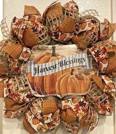 a wreath made out of burlocks and pumpkins with the words harvest blessing on it