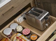 a toaster and other food items are sitting in a drawer on the kitchen counter