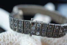 "This is the perfect option for those who like cool, unique jewelry and the luxury, shine of sterling silver . This bracelet is well made, cute and/or elegant in design, and very desirable. The bracelet is decorated with gray and clear cz . The clasp is in good working condition. The clasp is with safety hook. This bracelet is hard to find. The Wachenheimer Brothers Company of Providence, Rhode Island, started business in 1907. The bracelet is marked on the back of the catch Sterling Diamonbar P Vintage Silver Diamond Bracelet With Single Cut Diamonds, Art Deco Silver Diamond Bracelets, Art Deco Diamond Bracelet In Silver, Luxury Silver Bracelets With Single Cut Diamonds, Art Deco Silver Diamond Bracelet, Art Deco Silver Bracelets With Single Cut Diamonds, Art Deco Silver Bracelet With Single Cut Diamonds, Antique Hand Set Silver Jewelry, Art Deco Silver Bracelets With Diamond Accents