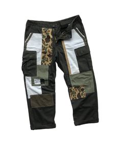 "Description: Uniqueness is here for those who love‼️ It's originally military pants in olive green herringbone pattern. Then, it's artistically full hand reworked and patched using several fabric materials and patterns, in order to make it unique and precious. However, its cargo style still remains as original since it contains multiple pockets like other military pants. Photos and videos describes the product better. So, just have a look-see at them all and read the special features below before you decide to purchase it.  Features: - Patchwork military pants. - Reworked cargo pants with multiple pockets. - Different fabric patterns and materials were patched as detailing.  - Full hand sewing stitches. - Herringbone pattern fabric. - Relaxed fit. Size: Waist: 33 - 37\" (Adjustable)  Hips Utility Style Cotton Pants With Patchwork, Cotton Utility Pants With Patchwork, Utility Cotton Patchwork Pants, Military Style Khaki Jeans With Cargo Pockets, Utility Style Patchwork Bottoms For Streetwear, Utility Patchwork Bottoms For Streetwear, Utility Cotton Patchwork Bottoms, Cotton Utility Patchwork Bottoms, Olive Military Cargo Pants With Patch Pockets