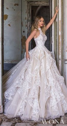 a woman in a wedding dress posing for the camera