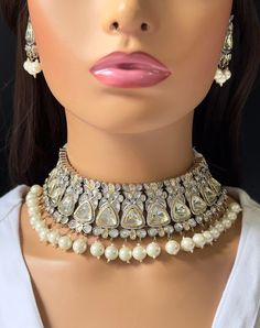 Elevate your style with this exquisite White Premium Dual Tone uncut Polki Kundan Victorian Necklace. Inspired by the glamour of Indian and Bollywood fashion, this stunning piece is fit for a celebrity. With fine craftsmanship and a touch of Sabyasachi elegance, this necklace exudes a regal charm perfect for any special occasion. Channel your inner Pakistani or Punjabi princess with this luxurious Kundan necklace that will surely make you the star of the show. Regular size and adjustable with si Elegant Traditional Wear With Meenakari For Parties, Bollywood Style Necklace For Navratri Party, Festive Designer Kundan Necklace With Stone Work, Bollywood Style Designer Jewelry With Zari Work, Bollywood Style Jewelry With Zari Work For Designer Wear, Bollywood Style Party Necklace With Zari Work, Bollywood Party Necklace With Zari Work, Bollywood Zari Work Necklace For Party, Festive Designer Chandbali Kundan Necklace