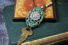 This one of a kind upcycled assemblage necklace features a vintage brass Chicago key, a re-purposed vintage crystal rhinestone button attached to a verdigris patina filigree and vintage glass champagne colored pearls. All hand wrapped together with antiqued brass wire.  Steampunk style with a glam edge!  Measures approximately 19 3/4"  Thank you for looking, see my shop for more: labellesavage.etsy.com Follow on Instagram @labellesavage If you like sculptural jewelry visit my new shop at hollyla Key Necklace Vintage, Colored Pearls, Glass Champagne, Sculptural Jewelry, Style Steampunk, Assemblage Necklace, Vintage Key, Key Jewelry, Rustic Glam