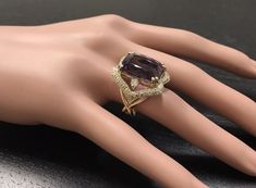 13.50 Carats Natural Amethyst and Diamond 14K Solid Yellow Gold Ring Suggested Replacement Value: $7,400.00 Total Natural Cushion Shaped Amethyst Weights: Approx. 12.00 Carats Amethyst Measures: 17.00 x 13mm Natural Round Diamonds Weight: Approx. 1.50 Carats (color G-H / Clarity SI1-SI2) Ring size: 7 (free re-sizing available) Ring total weight: Approx. 12.00 grams Disclaimer: all weights, measurements and colors are approximate and may vary slightly from the listed dimensions or as seen in the Luxury Purple Diamond Ring For Formal Occasions, Luxury Amethyst Ring With Prong Setting, Luxury Amethyst Ring With Diamond Accents For Anniversary, Luxury Multi-stone Amethyst Wedding Ring, Luxury Diamond Ring With Amethyst Accent Stones, Luxury Amethyst Diamond Ring With Accent Stones, Luxury Amethyst Diamond Ring For Formal Occasions, Luxury Amethyst Ring With Diamond Accents As Gift, Luxury Multi-stone Amethyst Ring For Weddings