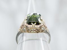 Made with lustrous white gold and a stunning emerald cut green tourmaline, this ring is guaranteed to catch the eye. Perfect for any occasion, this solitaire ring is a must-have addition to your jewelry collection.Metal: 18K White GoldGem: Green Tourmaline 2.41 CaratsGem Measurements: 7.0 x 8.8 mm, Emerald CutRing Size: 3.75Marks: "18K" Stamped on the inside band Pocket Watch Chain, Watch Chain, Green Tourmaline, The Eye, Pearl Pendant, Charm Earrings, Beaded Chain, Solitaire Ring, Emerald Cut