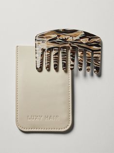 The travel-size mini Mocha Marble Detangling Comb is perfect for smoothing flyaways on the fly (espresso drink not included). Crafted from marbled cellulose acetate, which creates less static than other materials. This wide-tooth comb is crafted for gentle detangling and comes with a cream-colored vegan bio-based leather storage case. All sales final. faq what-is-the-mini-detangling-comb what-are-the-dimensions-of-the-mini-detangling-comb can-i-return-or-exchange-the-en-suite-spa-kit Espresso Drink, Detangling Comb, Holiday Wishlist, Luxy Hair, Straight Hair Cuts, Leather Storage, Wide Tooth Comb, Cellulose Acetate, Hot Nails