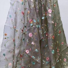 Grey Pure Silk Organza Embroidered Fabric by the yard Indian Embroidery Bridal Sheer Floral Wedding Dress Delicate Designer Dress Material Saree  ➤Material: 100% Pure Silk Organza ➤ Color: Powder Green, Pink, Blue, Brown Embroidery on Grey Organza Silk Fabric. ➤ Width: 44 Inches ➤ Code: sfe59 ➤ Listing for 1 yard of fabric.  This is a beautiful Organza Silk Fabric with delicate embroidery will add glamour to your special occasion. Gentle to touch and feels great on your skin. If you like working with natural fibers this fabric is for you. Will work very well for wedding dresses, gowns, crafty projects, hair accessories, veils, hats.  Wash & Care/Fabric Handling Instructions: ➤Do not wash ➤Iron at Medium Heat ➤No Steam Iron ➤Dry Clean only ➤Hang Under Shade If you purchase more than 1 yard Wedding Dress With Multicolor Embroidery, Multicolor Embroidered Dress For Wedding And Festive Occasions, Festive Multicolor Embroidered Dress For Wedding, Multicolor Embroidered Zari Work Dress For Wedding, Festive Multicolor Embroidered Wedding Dress, Multicolor Floral Embroidered Organza Lehenga, Multicolor Embroidered Semi-stitched Dress For Wedding, Wedding Dress With Multicolor Resham Embroidery, Traditional Embroidered Dress With Sheer Dupatta For Wedding