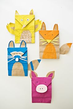 four paper bags with animals on them and one has an envelope in the shape of a fox