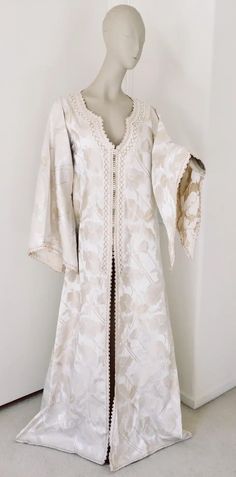 For Sale on 1stdibs - Elegant Moroccan white ivory and old brocade kaftan embroidered with gold trim threads. Size L to XL circa 1980s. This long maxi dress kaftan is embroidered White Floor-length Dress With Gold Embroidery, Middle Eastern Outfits Women, White Intricately Embroidered Festive Kaftan, Festive White Intricately Embroidered Kaftan, White Kaftan With Intricate Embroidery For Eid, White Embroidered Kaftan For Eid, Elegant Spring Kaftan With Intricate Embroidery, Gold Bohemian Kaftan For Wedding, White Floral Embroidered Wedding Kaftan