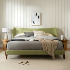 a bedroom with a green bed and white walls