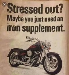 an advertisement for a motorcycle is displayed on the wall in front of a door that says, stressed out? maybe you just need an iron supplement