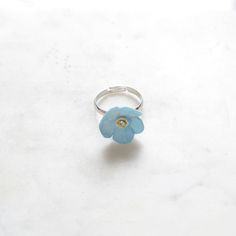 Beautiful porcelain forget me not ring is hand painted and embellished with Swarovski crystal detail.  Each piece is unique and hand finished. Flower size: L2xW2xH0.8 cm. Weight: 10 grams.  Ring is silver plated and adjustable size.  They looks so special when stack them with ladybird or butterfly ring from the same range. Great for everyday wear for both yourself and your loved one. Jewellery Care: Our jewellery is made from porcelain and should be treated as fragile. We recommend that customers should always remove your jewellery when applying scent, lotions and potions, or even better, always put your jewellery on last when getting dressed. Please note that chlorine is especially damaging to jewellery. Ensure that you rinse off any chemicals that come into contact with your jewellery st Adjustable Flower Enamel Ring As Gift, Flower Shaped Enamel Wedding Rings, Adjustable Blue Flower Ring, Forget Me Not Ring, Porcelain Earrings, Ring Flower, Butterfly Ring, Butterfly Jewelry, Stacked Jewelry