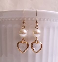 Gorgeous earrings feature 8mm Swarovski pearls with heart shape faceted glass encased in golden frame dangling below. On gold plated over brass earwires. Great for everyday wear or gift to a special one!! MEASUREMENTS: Earring length: 40mm Drop size: 27mm For matching bracelet, please click to this link: https://www.etsy.com/hk-en/listing/1128500457/ Purchase over $40 enjoys free shipping! Coupon code 'freeshipping1'. Free Gift Wrapping on request - All items that are gift wrapped come in with a Gold Heart Cut Earrings For Wedding, Gold Heart Cut Wedding Earrings, Heart-shaped Pearl Earrings For Formal Occasions, Classic Double Heart Earrings For Wedding, Classic Double Heart Wedding Earrings, Elegant Gold Faceted Crystal Earrings, Gold Dangle Pearl Earrings For Valentine's Day, Elegant Heart Cut Crystal Earrings For Party, Elegant Gold Double Heart Earrings