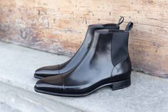 Unique Chelsea Boots Up For Grabs! After extreme popular demand, we brought some limited stock of these unique Carlos Santos Handgrade Chelsea Boots in Black Calf with Folded Stitching. Goodyear Welted in Portugal on the 387 Soft Square Last on a Handgrade Sole with Full Grain Black Calfskin Leather. Sizing Advice About the 387 Last: An chiseled last with a soft-squared toe and futuristic look. Perfect for lovers of the Adelaide and Italian shoes. Fits true to size and advice is to size down one Goodyear Welted Pointed Toe Fitted Boots, Luxury Chelsea Boots For Galas With Goodyear Welt, Fitted Chelsea Boots With Rubber Sole For Business, Fitted Snip Toe Chelsea Boots For Business, Formal Snip Toe Chelsea Boots, Black Closed Toe Chelsea Boots For Formal Occasions, Black Chelsea Boots With Leather Sole, Black Leather Sole Chelsea Boots, Black Leather Sole Chelsea Boots With Closed Toe