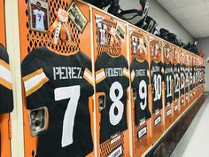 an orange locker with black and white jerseys on it