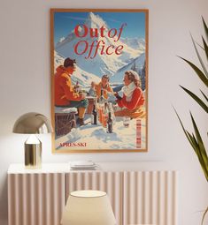 an old poster hangs on the wall next to a table with two chairs and a lamp