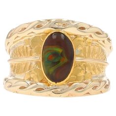 Size: 6 1/4 Metal Content: 14k Yellow Gold & 24k Yellow Gold Stone Information Natural Fire Agate Cut: Oval Cabochon Style: Solitaire Theme: Leaves Features: Textured Detailing Measurements Face Height (north to south): 5/8" (15.2mm) Rise Above Finger: 3/16" (4.5mm) Weight: 12 Grams Stamps: 14k, 24k, maker's mark Condition: Pre-Owned Condition Note: The fire agate displays light abrasions but they do not detract from the ring's overall beauty or functionality. Professionally cleaned, polished, a Fire Agate, Rise Above, La Face, Gold Stone, Light Display, Oval Cabochon, The Fire, Solitaire Ring, Makers Mark