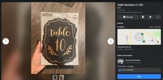 someone is holding up a table sign on their tabletop with the text table 10 in gold and black