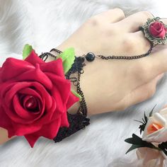 Design Concept Enhance your ensemble with this beautifully crafted Gothic Rose Ring Bracelet. Perfect for adding a touch of vintage charm to any outfit, this unique piece is designed to make a statement. This bracelet features a striking red rose centerpiece, symbolizing timeless elegance and love. The intricate black chain and lace details add a Victorian flair, making it perfect for themed events or everyday wear. Made from high-quality materials, this rose ring bracelet is designed for durabi Rose Metal Jewelry For Party, Vintage Bracelet Jewelry For Valentine's Day, Metal Rose Design Jewelry For Valentine's Day, Valentine's Day Metal Jewelry With Rose Design, Victorian Rose Gold Bracelets As Gift, Victorian Rose Gold Bracelets Gift, Vintage Rose Gold Metal Bracelets, Metal Rose Design Jewelry For Wedding, Vintage Flower Shaped Jewelry For Party