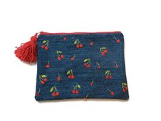 a small blue pouch with cherries on it