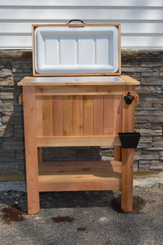 an ice chest sitting on top of a wooden bench