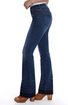 Partially made with sustainably sourced fibers, these stretchy jeans feature a relaxed fit and released hems that create a flared silhouette. 32" inseam; 20" leg opening; 9 3/4" front rise Zip fly with button closure Five-pocket style 67% cotton, 29% REPREVE® recycled polyester, 3% rayon, 1% spandex REPREVE recycled polyester is made from 100% post-consumer recycled plastic bottles Machine wash, tumble dry Imported Mid-rise Dark Wash Flares With Five Pockets, Mid-rise Dark Wash Flares With Frayed Hem, High Rise Stretch Dark Wash Flares, Stretch High Rise Dark Wash Flares, Dark Wash Stretch Flare Pants, Flare Jeans With Frayed Hem, Denim Blue Stretch Straight Leg Flares, Stretch Denim Blue Straight Leg Flares, Straight Leg Stretch Flares With Frayed Hem