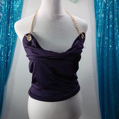 Elevate Your Party Style With This Stunning And Sexy Tube Top From Thirty Thirty. The Cowl Neck With Gold Chain Strap Adds A Touch Of Sophistication To This Purple Top, Which Is Perfect For Summer And Spring. The Lightweight And Stretchy Fabric Made From Polyester And Spandex Ensures A Comfortable Fit And Easy Movement While You Dance The Night Away At The Club. This Top Is Perfect To Wear For Any Party Or Cocktail Event And Can Be Paired With Your Favorite High-Waisted Skirt Or Jeans. The Sleeveless Design And Pullover Closure Make It Easy To Wear, And The Regular Fit Will Flatter Any Body Type. Don't Miss Out On This Stylish And Versatile Addition To Your Wardrobe. Cocktail Event, Party Style, Purple Top, Dolce E Gabbana, The Club, Party Fashion, Stretchy Fabric, Tube Top, Chain Strap