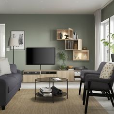 a living room filled with furniture and a flat screen tv on top of a wall