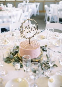 the tables are set with white and pink linens, silverware, and flowers